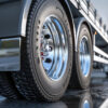 Close-up of a big rig truck wheel in a repair shop, highlighting the need for heavy-duty truck repair insurance to protect businesses from unexpected damages and liabilities.