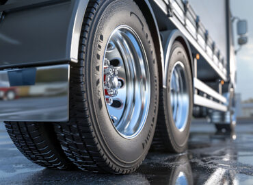 Close-up of a big rig truck wheel in a repair shop, highlighting the need for heavy-duty truck repair insurance to protect businesses from unexpected damages and liabilities.